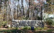 stone signage and nature-filled entrance to property